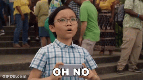 A Young Boy Wearing Glasses Is Holding A Cell Phone And Says Oh No GIF