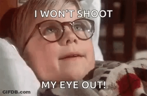 A Young Boy Wearing Glasses Is Laying In Bed With Blood On His Shirt . GIF