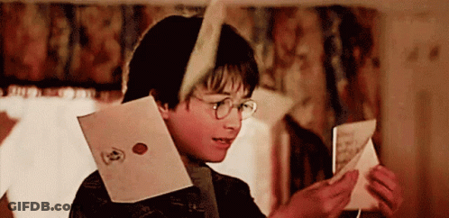 A Young Boy Wearing Glasses Is Reading A Letter GIF