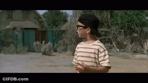 A Young Boy Wearing Sunglasses And A Baseball Cap GIF