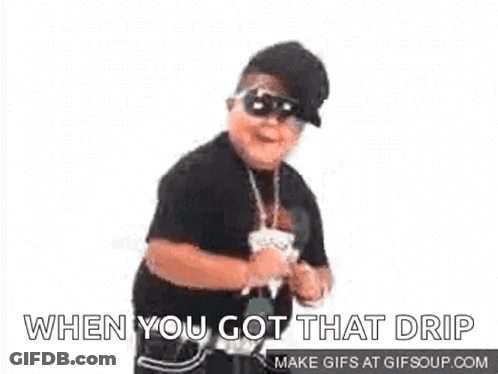 A Young Boy Wearing Sunglasses And A Hat Is Dancing . GIF