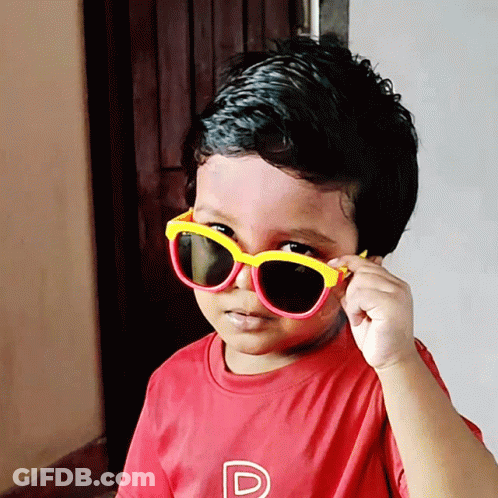 A Young Boy Wearing Sunglasses And A Red Shirt With A Letter P On It GIF