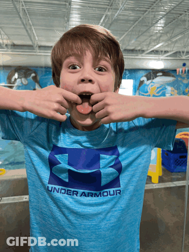A Young Boy Wears A Blue Under Armour Shirt GIF