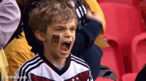 A Young Boy With A German Flag Painted On His Face Is Screaming GIF