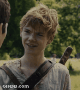 A Young Boy With A Sword On His Back Is Smiling And Talking To Another Person GIF