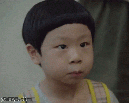 A Young Boy With A Very Short Haircut Is Making A Face GIF