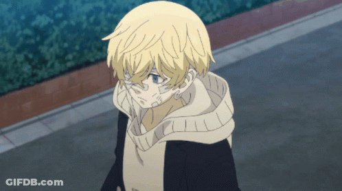 A Young Boy With Blonde Hair And Blue Eyes Is Walking Down A Street GIF