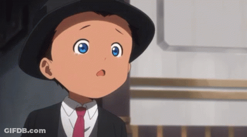 A Young Boy With Blue Eyes Is Wearing A Black Hat And Tie GIF