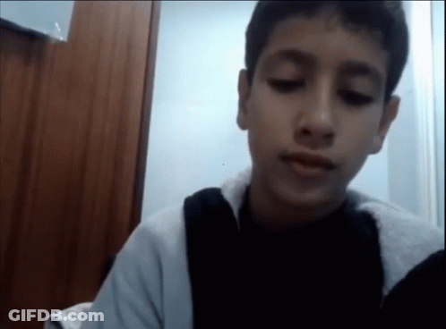 A Young Boy With His Eyes Closed And A Black Shirt On GIF