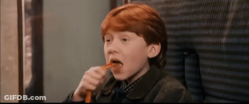 A Young Boy With Red Hair Is Eating A Carrot GIF
