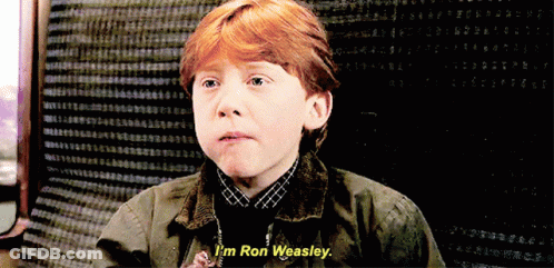 A Young Boy With Red Hair Says " I 'M Ron Weasley " In Front Of A Black Background GIF