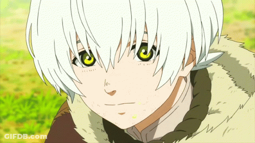 A Young Boy With White Hair And Green Eyes Is Looking At The Camera GIF