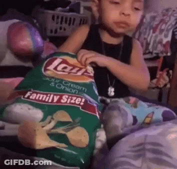 A Young Child Is Holding A Bag Of Lays Chips GIF