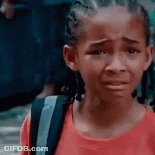 A Young Girl In A Red Shirt Is Crying With A Backpack . GIF