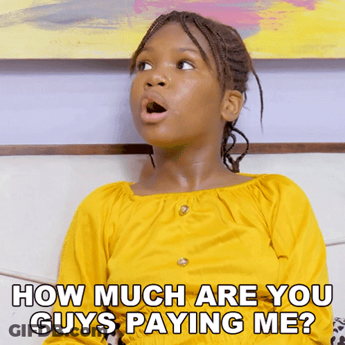 A Young Girl In A Yellow Shirt Is Sitting On A Couch And Asking How Much Are You Guys Paying Me GIF