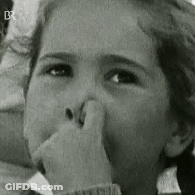 A Young Girl Is Covering Her Nose With Her Hand . GIF