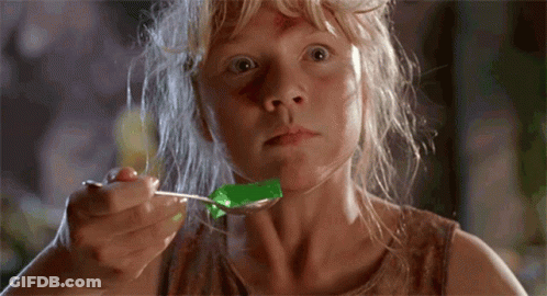 A Young Girl Is Eating Jelly With A Spoon GIF