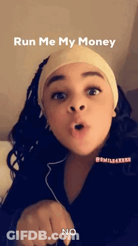 A Young Girl Is Making A Funny Face And Pointing At The Camera While Wearing A Headband . GIF