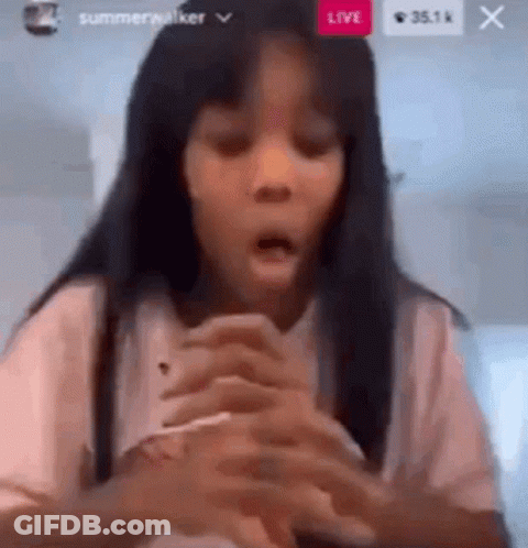 A Young Girl Is Making A Funny Face While Holding A Cell Phone . GIF