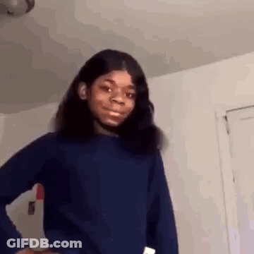 A Young Girl Is Standing In A Room With Her Hands On Her Hips And Making A Funny Face . GIF