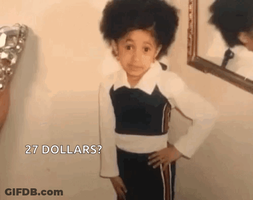 A Young Girl Is Standing In Front Of A Mirror . GIF