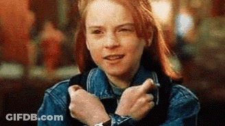 A Young Girl Wearing A Denim Jacket And A Watch Is Making A Funny Face . GIF