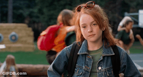 A Young Girl Wearing A Denim Jacket And Sunglasses GIF