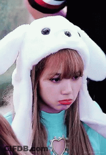 A Young Girl Wearing A White Bunny Hat With Ears . GIF