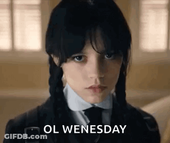 A Young Girl With Braids Is Wearing A School Uniform And A Tie And Says `` Ol Wednesday '' . GIF