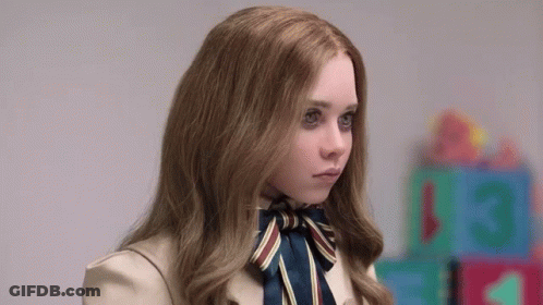 A Young Girl With Long Hair And A Bow Tie Is Standing In Front Of A Row Of Toys . GIF