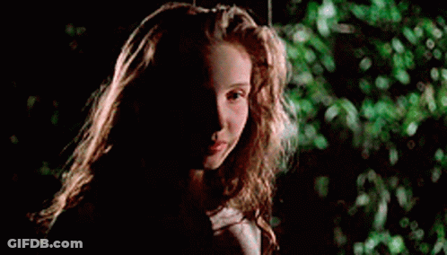 A Young Girl With Long Hair Is Sitting On A Swing In The Dark . GIF