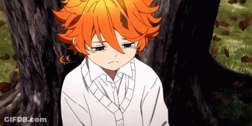 A Young Girl With Orange Hair Is Sitting Under A Tree With Her Eyes Closed . GIF