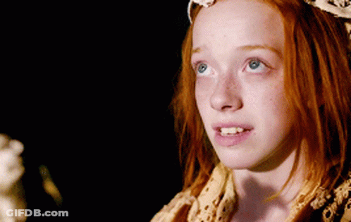 A Young Girl With Red Hair And Blue Eyes GIF