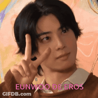 A Young Man Giving A Peace Sign With The Name Eunwoo De Eros Written Below Him GIF