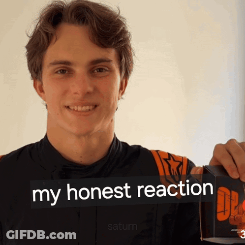 A Young Man Holding A Box That Says My Honest Reaction On It GIF