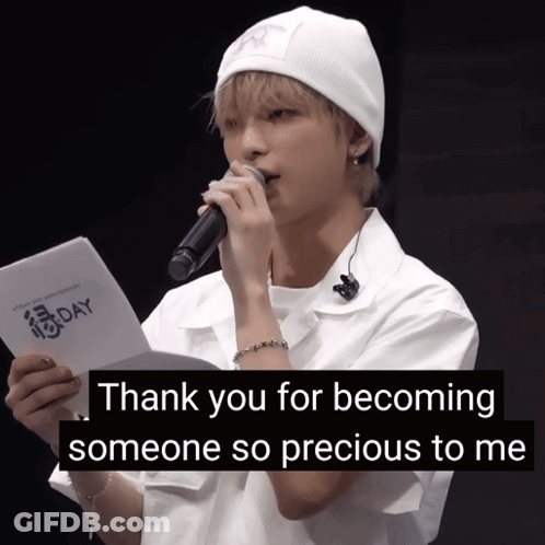 A Young Man Holding A Microphone And A Piece Of Paper That Says " Thank You For Becoming Someone So Precious To Me " GIF