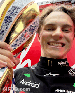 A Young Man Holding A Trophy That Says Android On His Shirt GIF