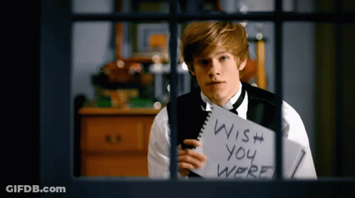 A Young Man Holds A Notebook That Says Wish You Were GIF