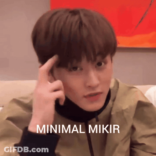 A Young Man Holds His Finger To His Forehead With The Words Minimal Mikir Written Below Him GIF