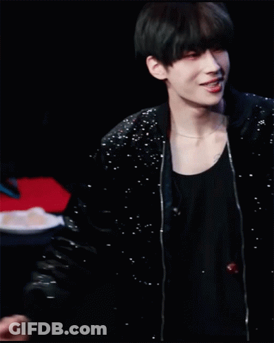 A Young Man In A Black Jacket Is Making A Heart Shape With His Hands On His Head . GIF