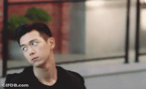 A Young Man In A Black Shirt Is Looking To The Side GIF