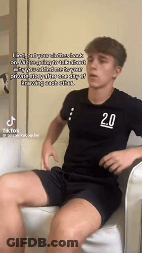 A Young Man In A Black Shirt With The Number 2.0 On It GIF