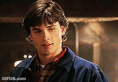 A Young Man In A Blue Jacket And Plaid Shirt GIF
