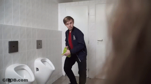 A Young Man In A Blue Jacket With A Sticker On It That Says ' A ' GIF