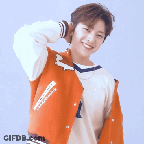 A Young Man In A Blue Shirt Has His Hand On His Forehead GIF