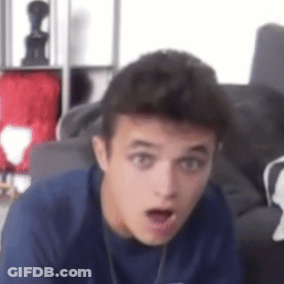 A Young Man In A Blue Shirt Is Making A Surprised Face . GIF