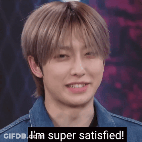 A Young Man In A Denim Jacket Is Smiling With The Words I 'M Super Satisfied Below Him GIF