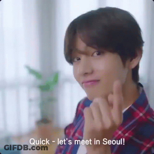 A Young Man In A Plaid Shirt Is Making A Heart Shape With His Fingers And The Words Quick Let 'S Meet In Seoul GIF