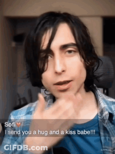 Young Man In Plaid Shirt Sending Hug And Kiss GIF
