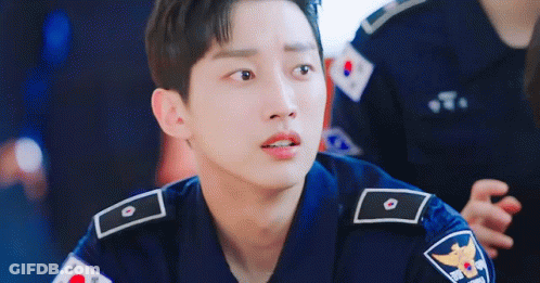 A Young Man In A Police Uniform Is Looking At The Camera With A Sad Look On His Face . GIF